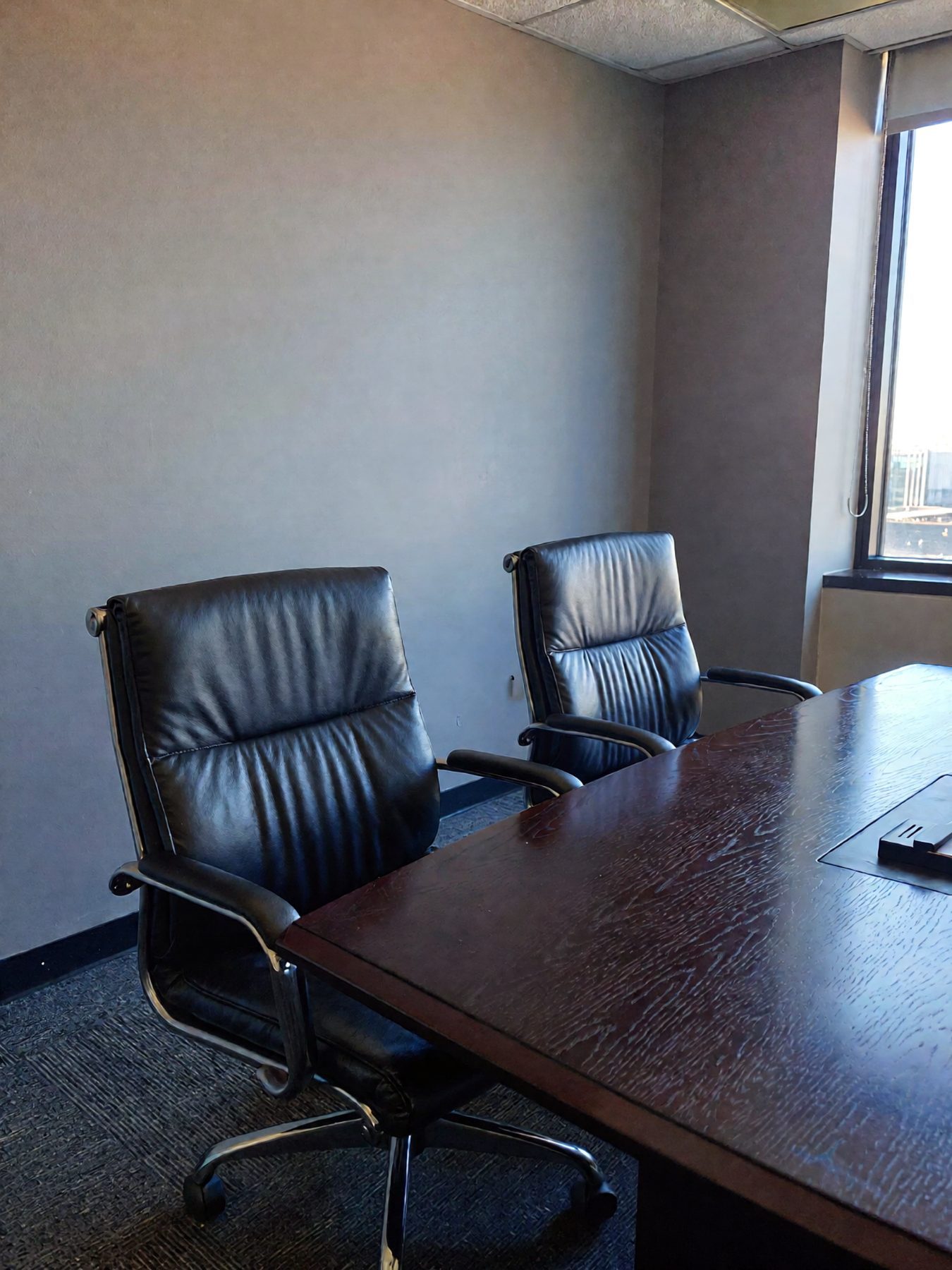 Two chairs facing each other across a meeting table