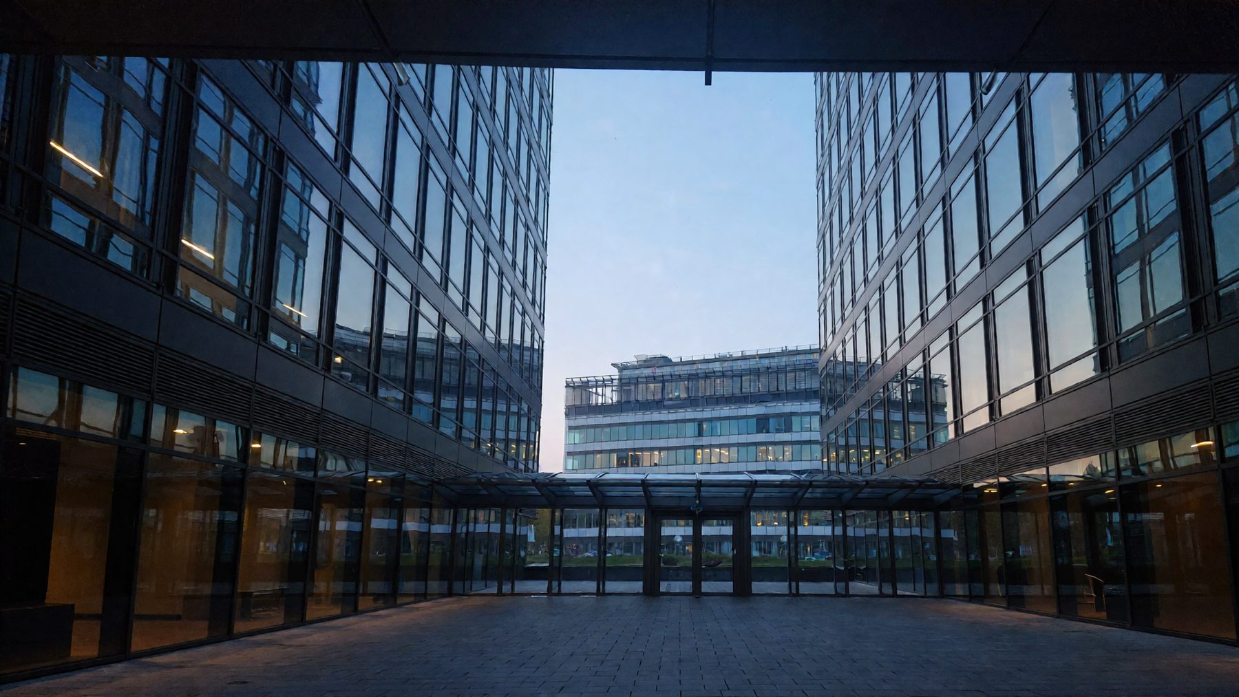 Glass office tower atrium in Vienna at dusk